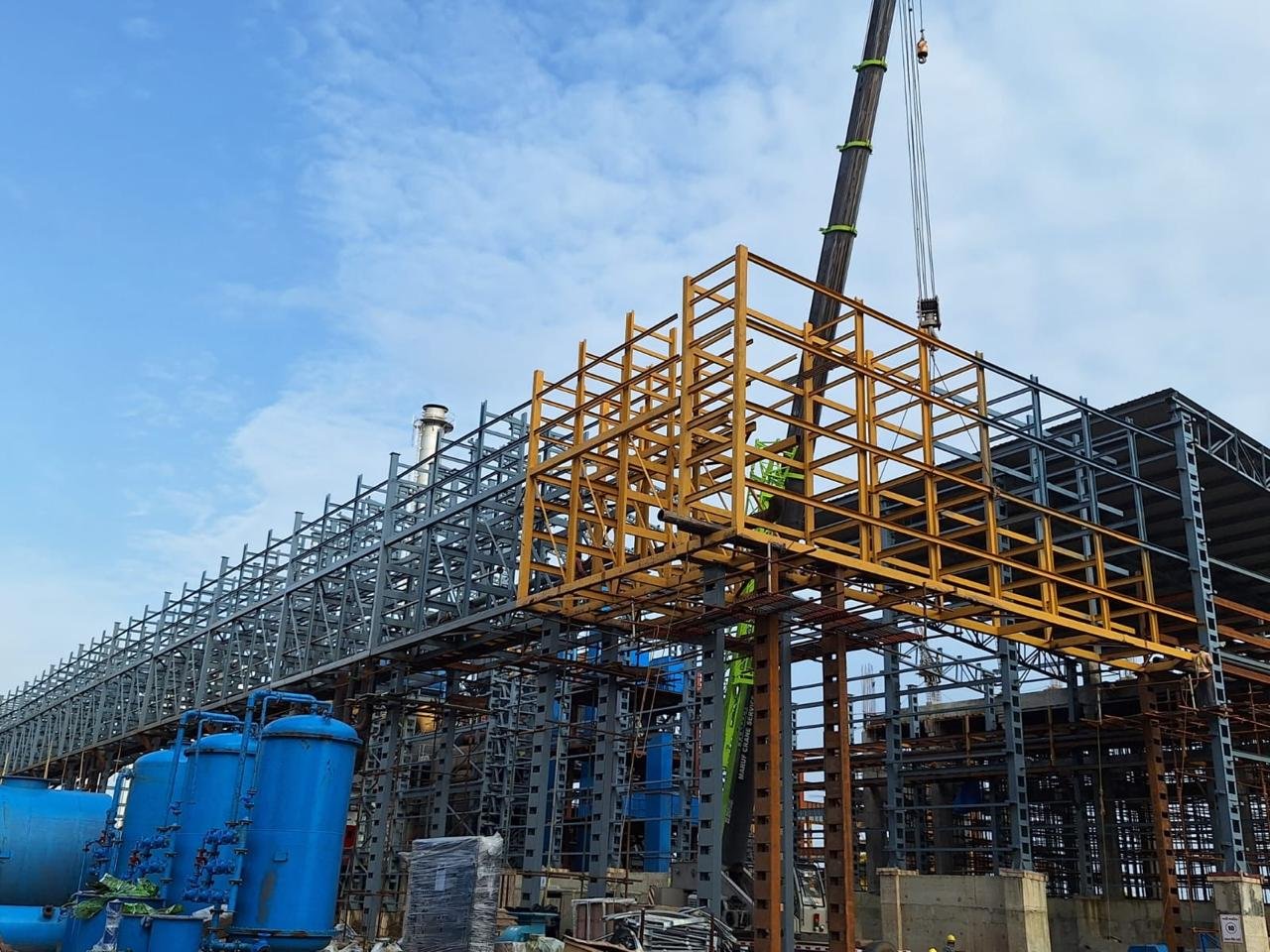 Steel framework and construction activity at an industrial site